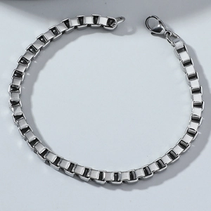 Close-up of silver stainless steel box chain bracelet featuring a secure lobster clasp
