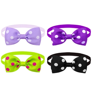 Detailed view of four colorful polka dot pet bowties in purple, green, and black
