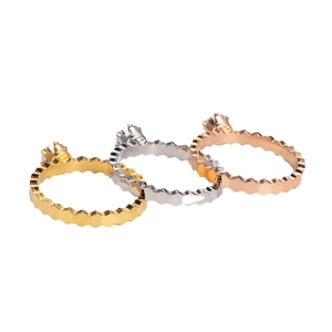 Three wavy stacking rings in gold, silver, and rose gold with sparkling zircon stones