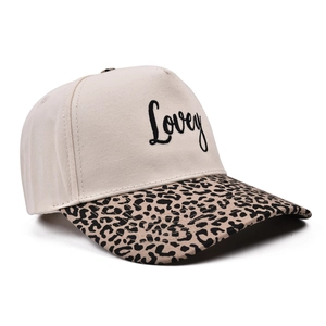 Detailed close-up of embroidered 'Lovey' text on a stylish leopard print brim cap