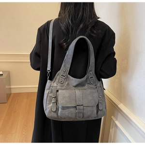 Macro view of vintage grey PU leather tote bag with buckle pocket and rivet detailing