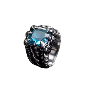 Detail of vintage dragon claw ring featuring a blue square zircon in antique silver finish