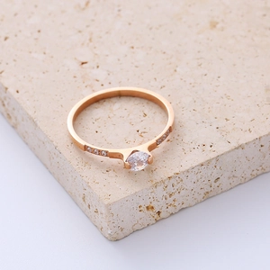 Minimalist rose gold titanium steel ring with central diamond and side accents