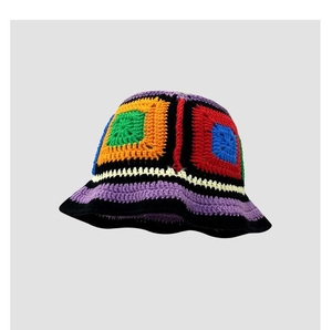 Detailed macro view of colorful handmade crochet knit floral pattern on the bucket hat