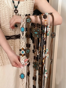 Detailed texture of bohemian braided waist chains with turquoise and metal pendants