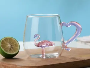 Detail of a clear glass mug with a 3D pink flamingo inside and a purple heart handle