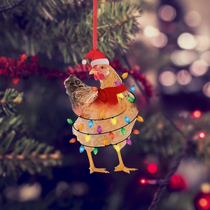 Detailed view of acrylic chicken pendant with Christmas hat and scarf on a tree