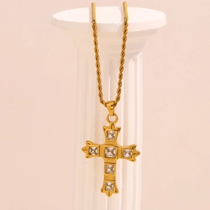 18K gold plated stainless steel cross necklace with cubic zirconia on roman column stand