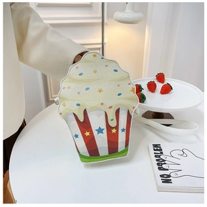 Detailed view of cupcake-shaped crossbody bag with glitter finish and star patterns