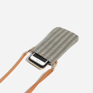 Vertical woven straw crossbody phone bag with black and white stripes and brown strap