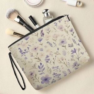 Floral print makeup bag with zipper closure and black wrist strap on elegant background