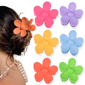 Detail view of flower hair claws in six matte candy colors with model showcase