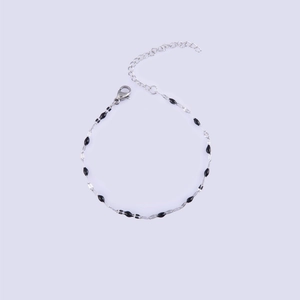 Detail view of silver stainless steel chain bracelet with black beads and lobster clasp