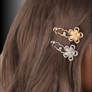 Elegant set of gold and silver Y2K flower hair clips with crystals and opals on hair