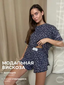 Detail of dark blue modal pajamas with white heart print and ruffled hem shorts