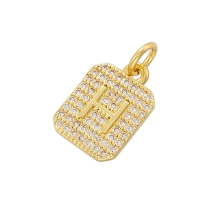 Detailed view of luxury gold rectangular pendant with pavé-set zircons forming letter H