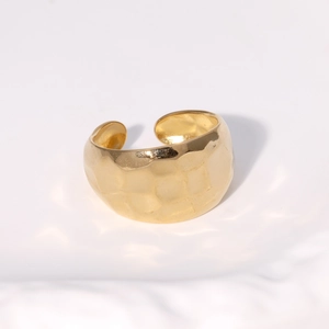 Minimalist adjustable gold stainless steel ring with hammered texture finish on white surface