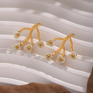 18K gold plated stainless steel branch earrings with white flowers on a textured base