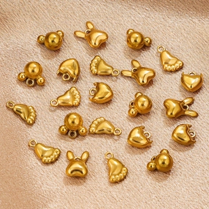 Golden stainless steel DIY charms in animal and heart shapes on golden fabric