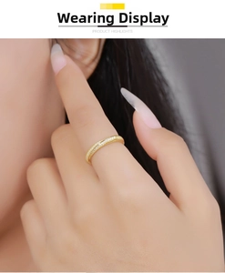 Moebius ring with sparkling moissanite diamonds worn on finger in golden finish