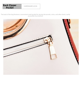 Detail view of cream leather bag with red trim and golden back zipper pocket