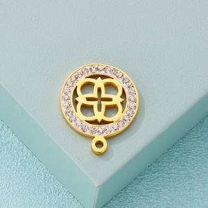 Golden hollow clover pendant with sparkling zircon border on a light blue background