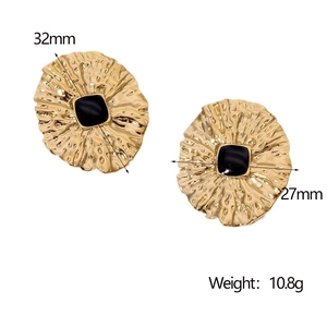 Detail showing vintage gold textured earrings with black center and size 32mm by 27mm