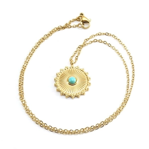 Golden stainless steel necklace featuring a turquoise sun pendant on a white background