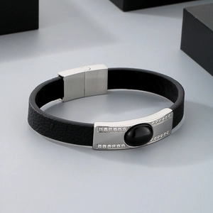 Detail of men's leather bracelet with stainless steel magnetic clasp and crystal accents
