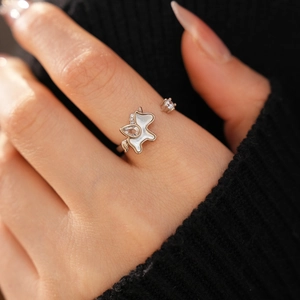 Detailed close-up of zircon unicorn ring with white mother of pearl on model finger