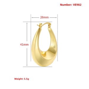 Macro detail of large gold-plated U-shaped hoop earrings with matte brushed texture finish