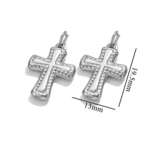 Macro shot of silver stainless steel cross pendants with beaded edge detailing