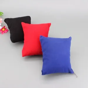 Velvet display pillows for watches and jewelry in black, red, and blue colors