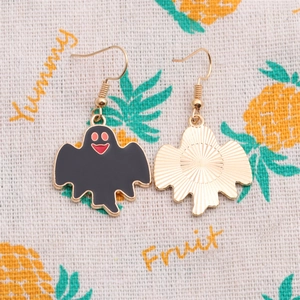 Detail showing front and back of ghost earrings with black enamel and fish hook wires
