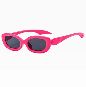 Detail of retro fuchsia oval narrow frame sunglasses with dark grey lenses in 90s style