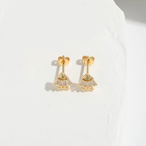 Macro shot of gold fan-shaped stud earrings with green stones and clear zircon accents
