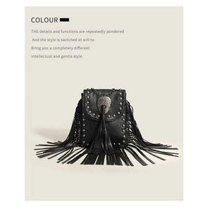 Close-up of black pebbled leather bag with metal skull, rivets, and long tassel details