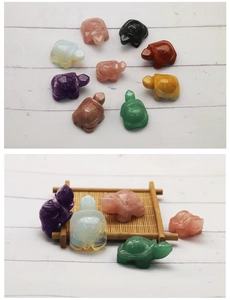 Detailed view of various carved crystal turtles in rose quartz and diverse gemstones