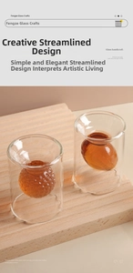 Close-up of double-walled whiskey glass with amber inner football and golf shapes