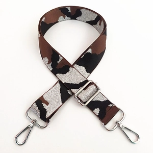 Close-up of adjustable camo canvas bag strap with silver metal swivel hooks