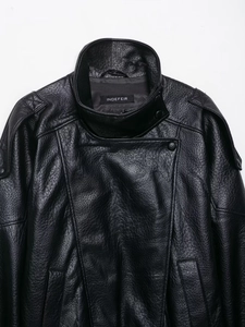 Close-up of the black faux leather jacket showing its premium pebble grain texture and collar