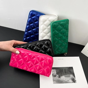 Glossy quilted faux leather clutch wallets in multiple vibrant colors with zipper closure