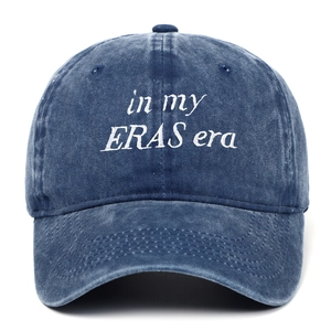 Close-up of white in my ERAS era embroidery on navy blue washed cotton baseball cap
