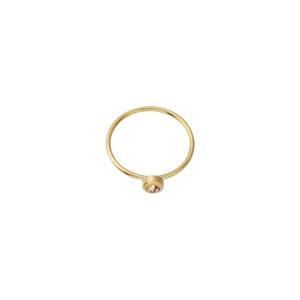 Detail of matte gold minimalist ring featuring a champagne birthstone in bezel setting
