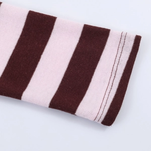 Macro view of pink and brown striped knit fabric with professional double-stitched hem
