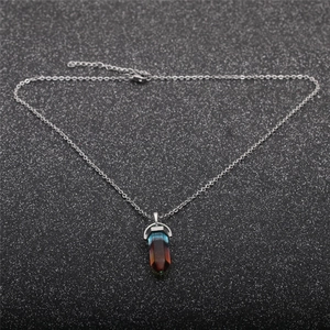 Hexagonal gemstone pendant necklace with blue-brown gradient on black glitter background