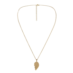 Detail of gold heart pendant necklace featuring hand-holding line art engraving