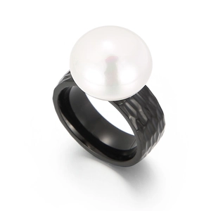 Hammered black stainless steel ring featuring a large white round pearl embellishment