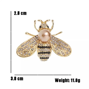 Detailed view of bee brooch with rhinestone wings and pearl back showing 3.8x2.8cm size