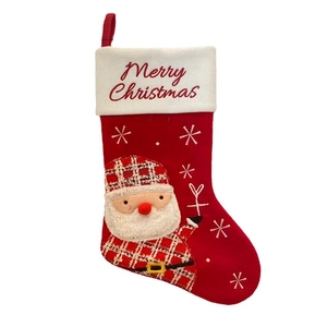 Red Christmas stocking with Santa Claus motif and white plush cuff for festive decoration